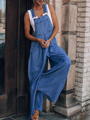 Denim overalls jumpsuit with wide palazzo legs in medium wash.