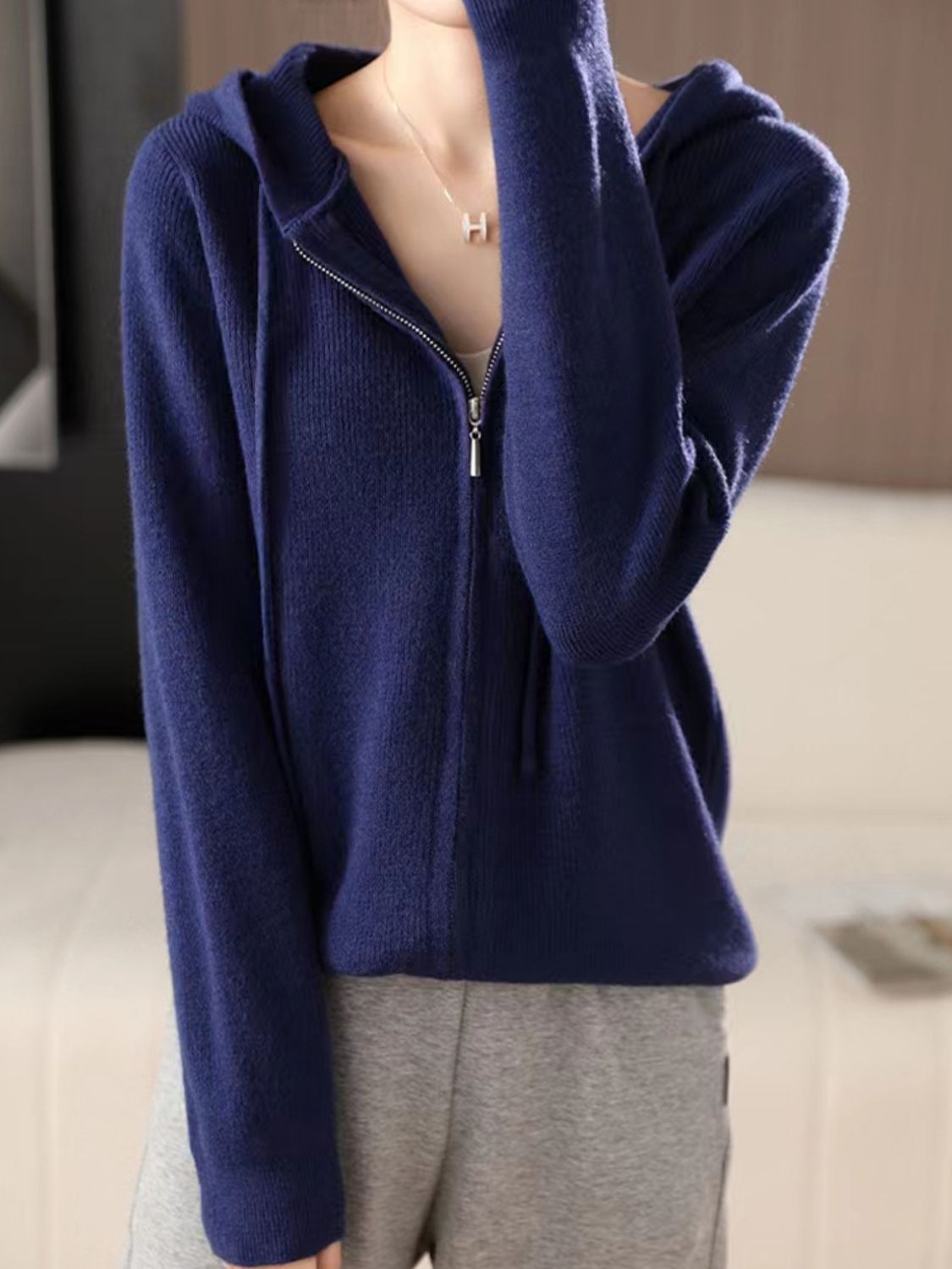 Dark Blue ribbed knit zip-through hoodie with a drawstring hood and silver zipper.
