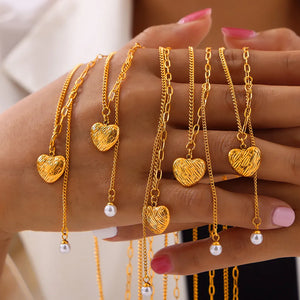 Gold textured heart necklaces with pearl drops on delicate chains