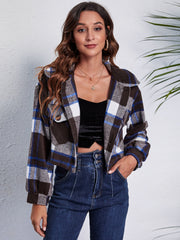 Chic plaid jacket in dark blue, white, and brown with buttoned pockets and collar.