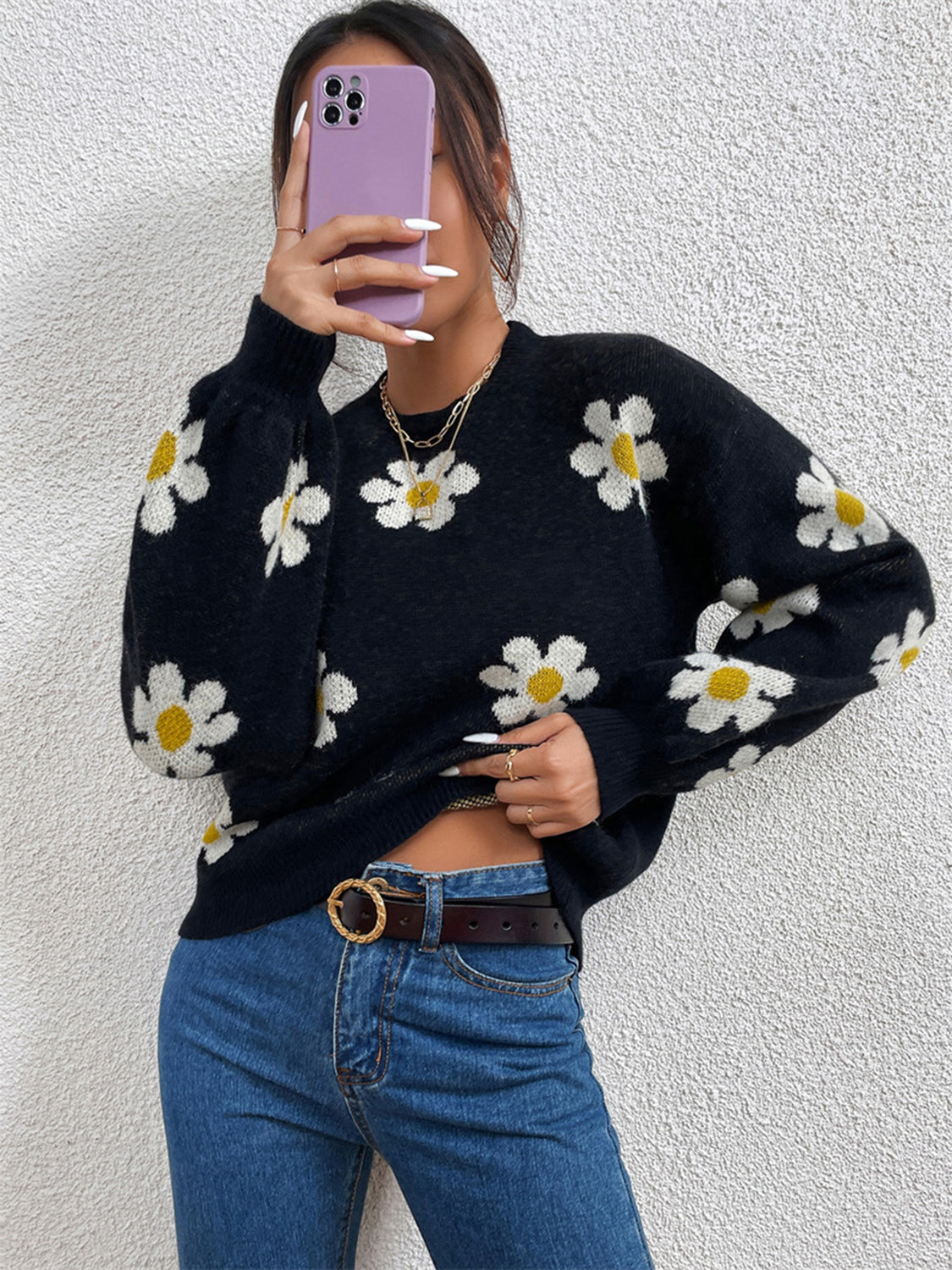 Black daisy print knit sweater with puff sleeves and crew neck.