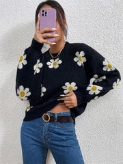 Black daisy print knit sweater with puff sleeves and crew neck.