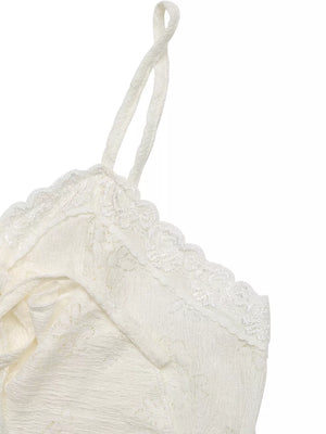 White lace camisole with ruffled hem and tie-front detail.