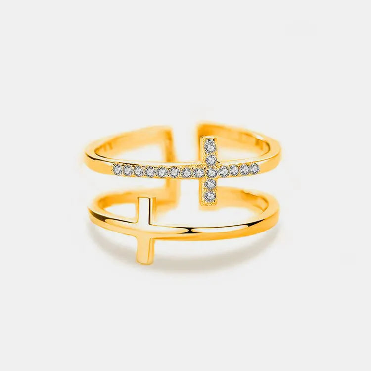 Gold double band ring with two cross embellishments, one with clear stones.
