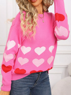 Rose red acrylic crew neck sweater with allover heart print and long sleeves.