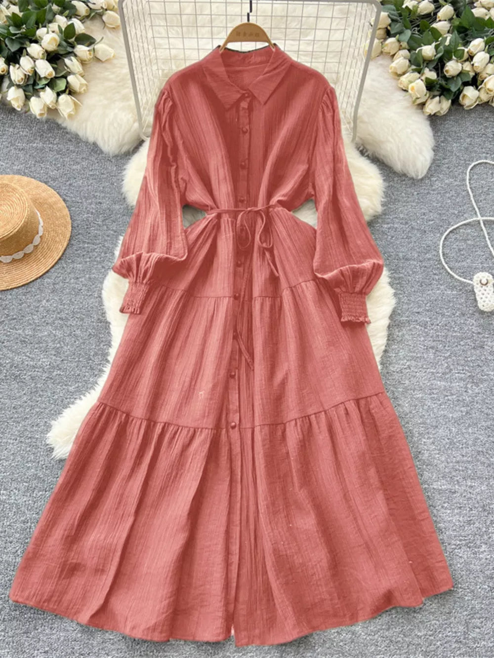 Burnt Coral textured tiered long sleeve button-down midi dress with tie waist.