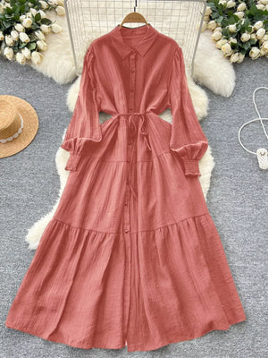 Burnt Coral textured tiered long sleeve button-down midi dress with tie waist.