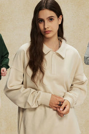 Oversized tan polo sweatshirt with collar and long sleeves.