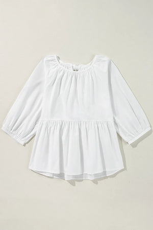 White babydoll blouse with gathered neckline, balloon sleeves, and tiered peplum hem.