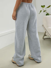 Light gray relaxed sweatpants with pleat-front detail and wide leg.