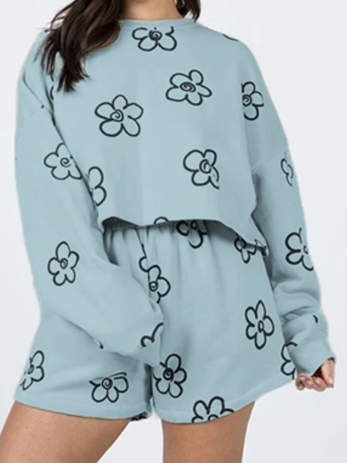 Teal cropped lounge set with black drawn floral print and matching shorts.