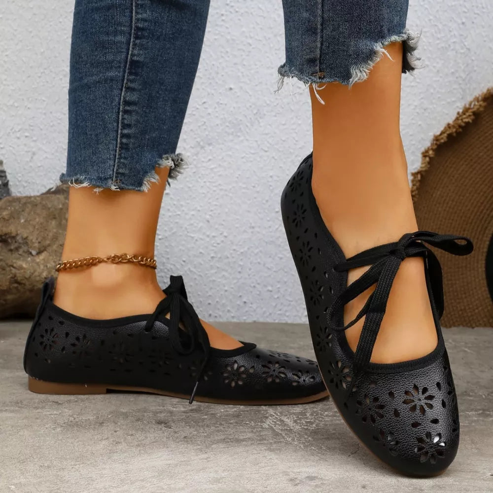 Black floral cutout slip-on flats with tie detail