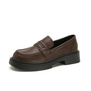 Platform penny loafers in coffee brown leather with a thick sole.