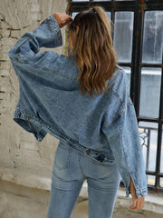 Light wash oversized denim jacket with buttoned patch pockets and wide sleeves.