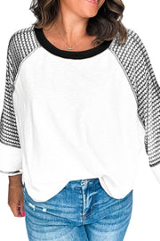 White raglan sleeve tee with black houndstooth pattern on sleeves and black neckline.