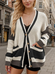 Waffle knit colorblock V-neck cardigan with button front and pockets.