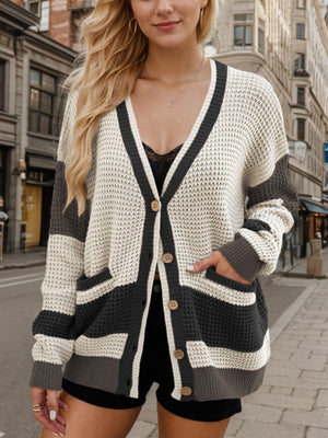 Waffle knit colorblock V-neck cardigan with button front and pockets.