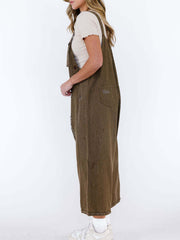 Brown relaxed fit denim overalls with ripped details and adjustable straps.