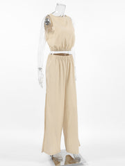 Tan sleeveless crew neck crop top and wide-leg pants set with elastic waistband and side slits.
