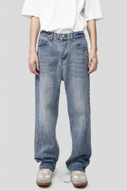 Pocketed denim jeans in medium wash, featuring a relaxed fit and classic five-pocket styling.