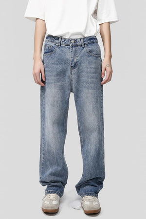 Pocketed denim jeans in medium wash, featuring a relaxed fit and classic five-pocket styling.