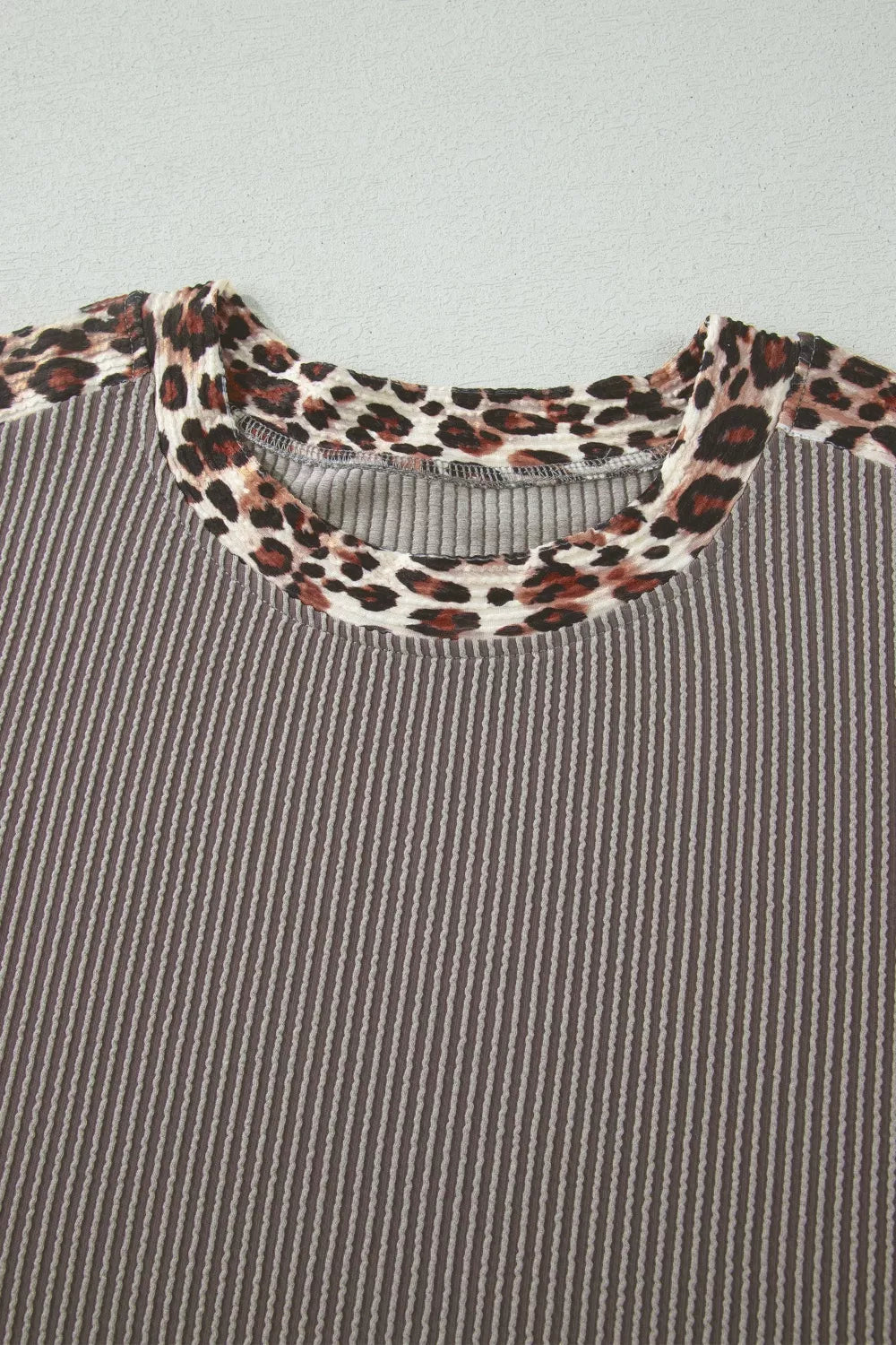 Ribbed knit two-piece set with leopard trim neckline and cuffs.