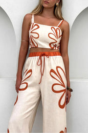 Floral print linen co-ord set with crop top and wide-leg pants in burnt orange.