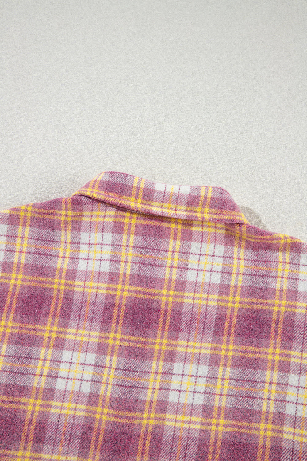 Oversized pink plaid button-down flannel shirt with a classic collar.