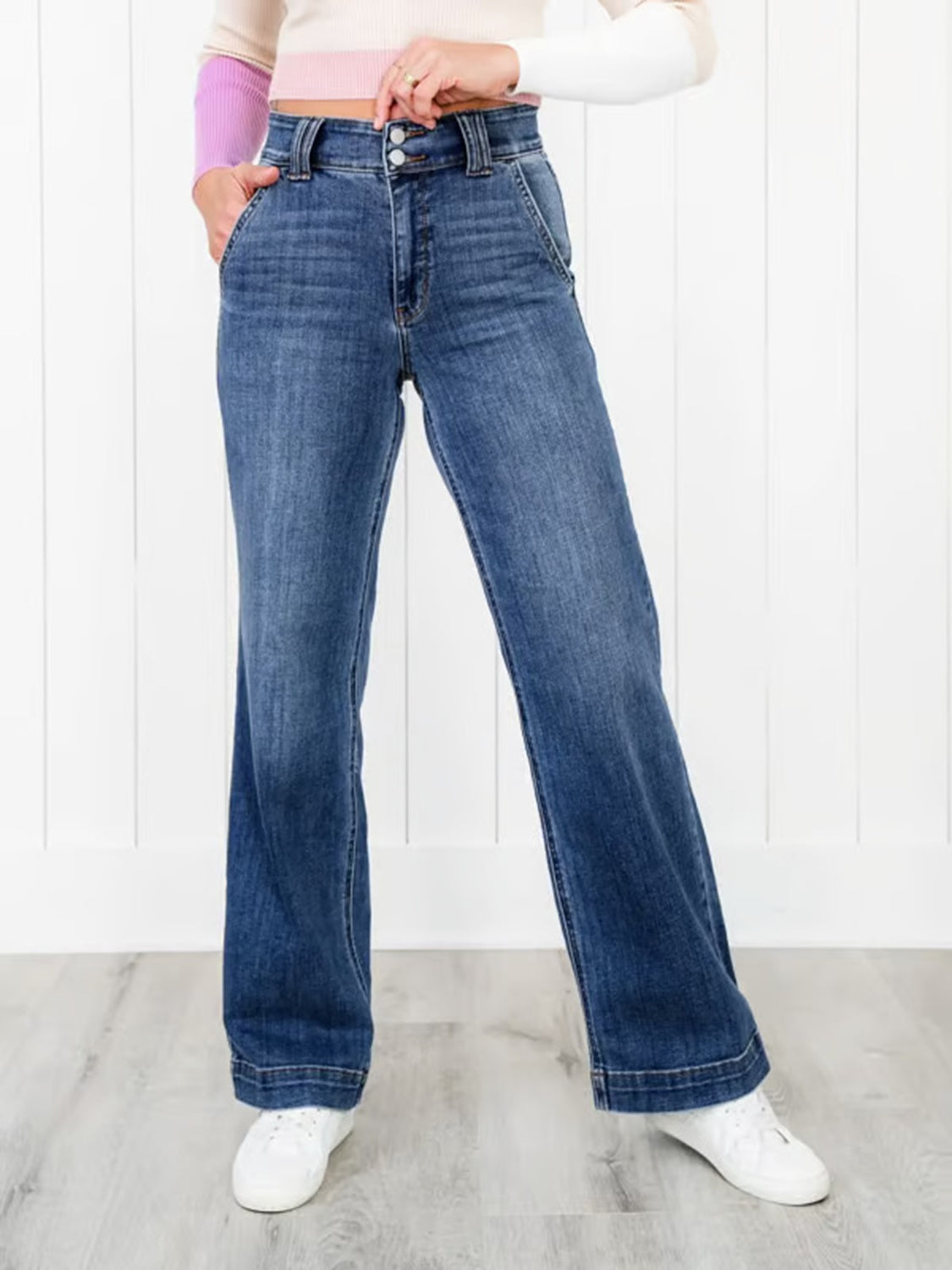 Medium wash denim jeans with wide legs and utility pockets.