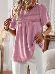 Blush pink textured puff sleeve blouse with lace yoke detail and short sleeves.