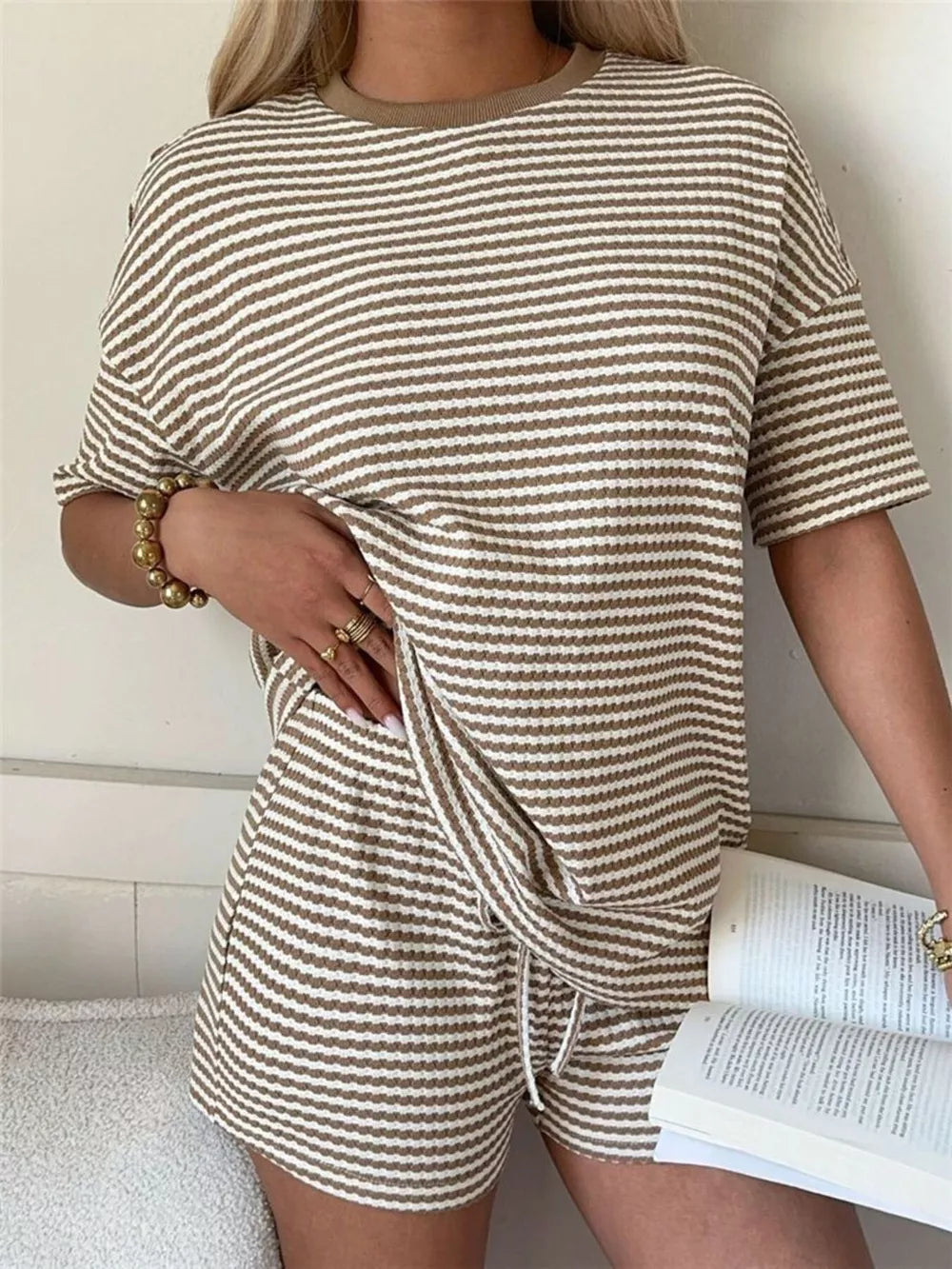 Khaki striped two-piece set with drawstring shorts and short sleeve top.