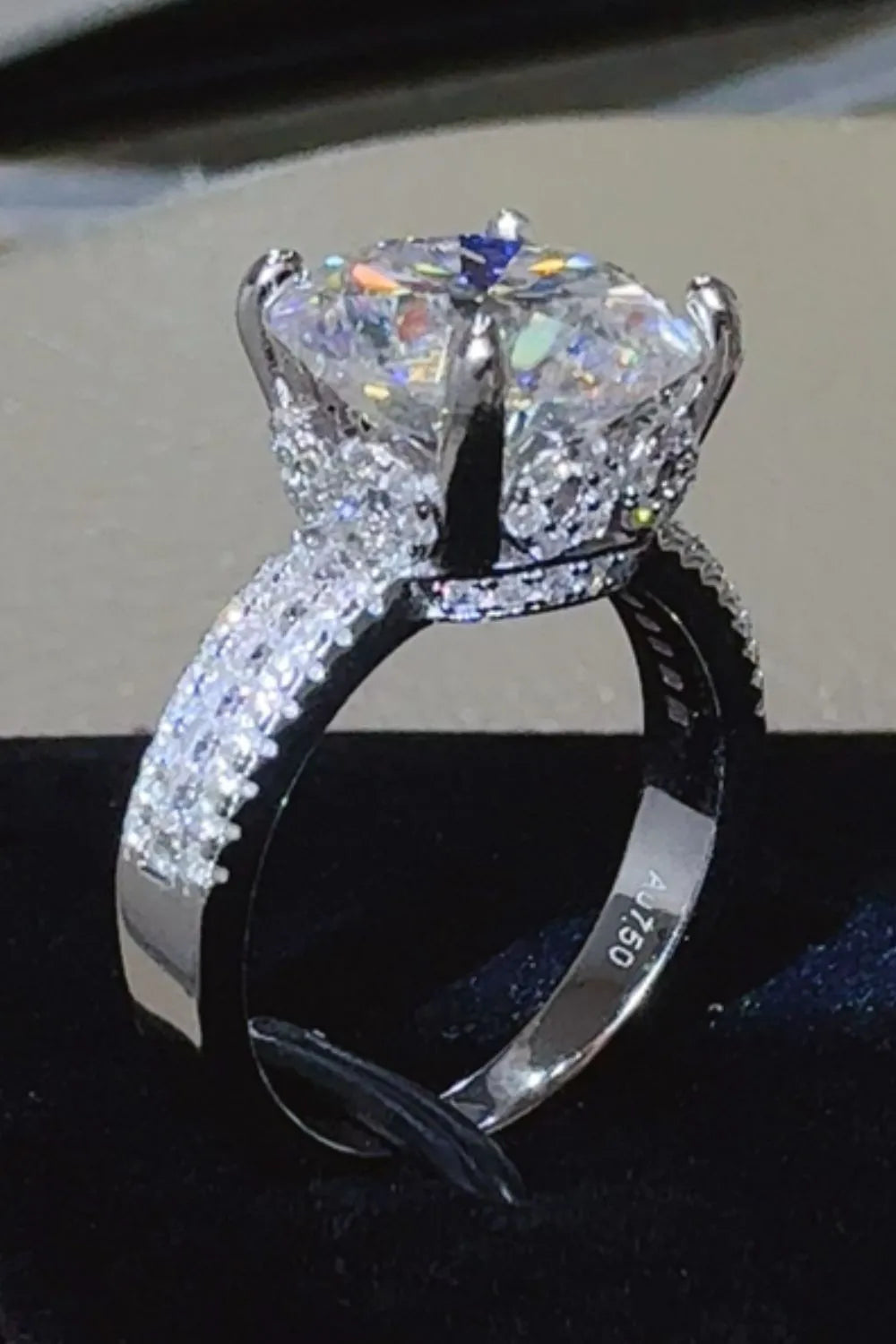 Silver moissanite crown ring with pavé band detail and a large center stone.