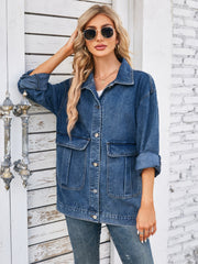 Chic denim button-up jacket in dusty blue with two chest pockets and button cuffs.