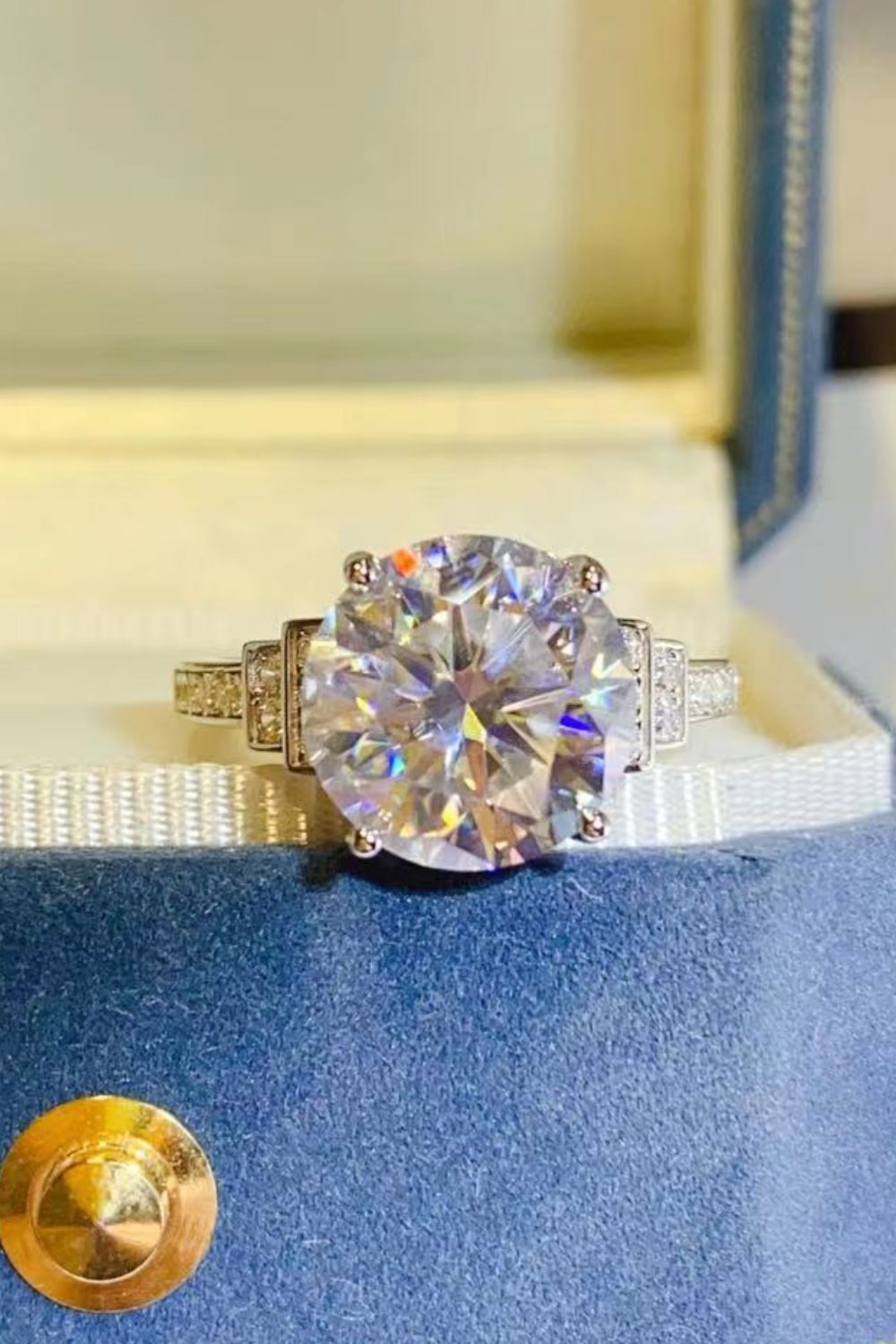 Radiant cut halo sterling ring with a large center stone and pavé band.