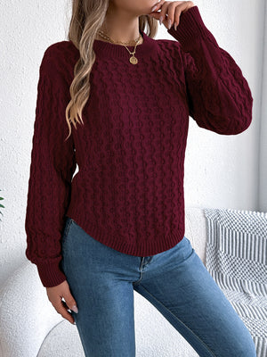 Burgundy cable knit sweater with asymmetric hem and crew neck.