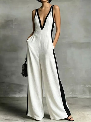 White wide-leg jumpsuit with deep V-neck and contrast trim.