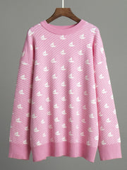 Blush pink knit sweater with allover white sailboat pattern and ribbed crewneck.