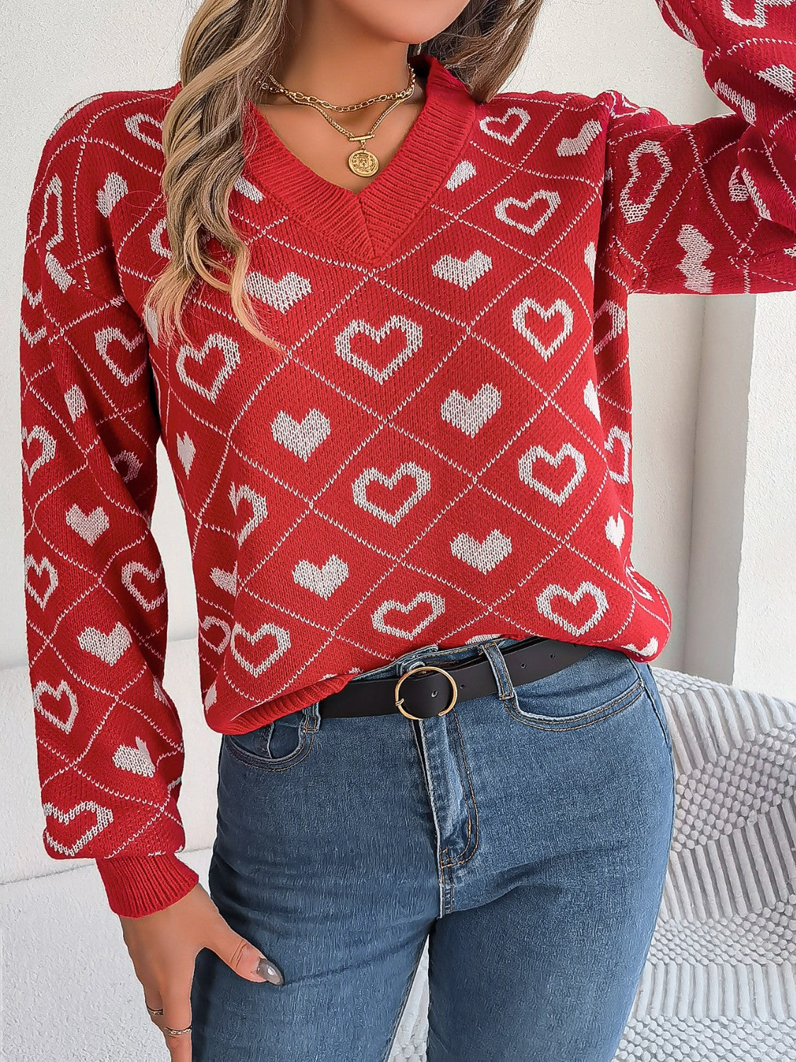 Deep Red V-neck knit sweater with allover white heart jacquard pattern and argyle details.