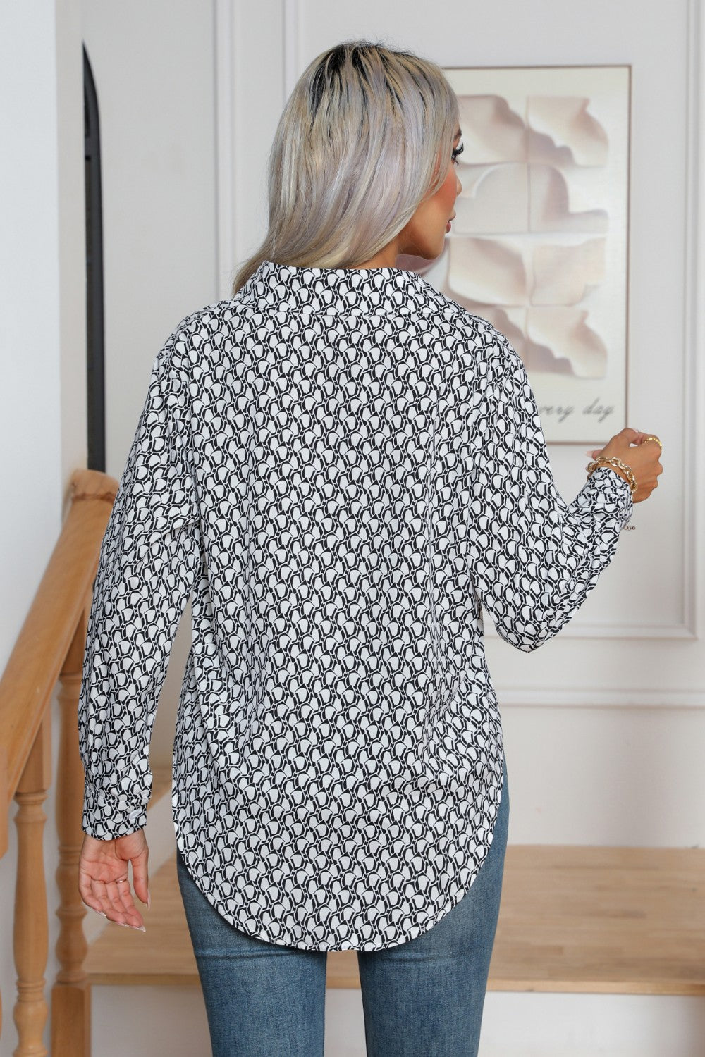 Collared blouse in black and white monogram print with buttoned cuffs.
