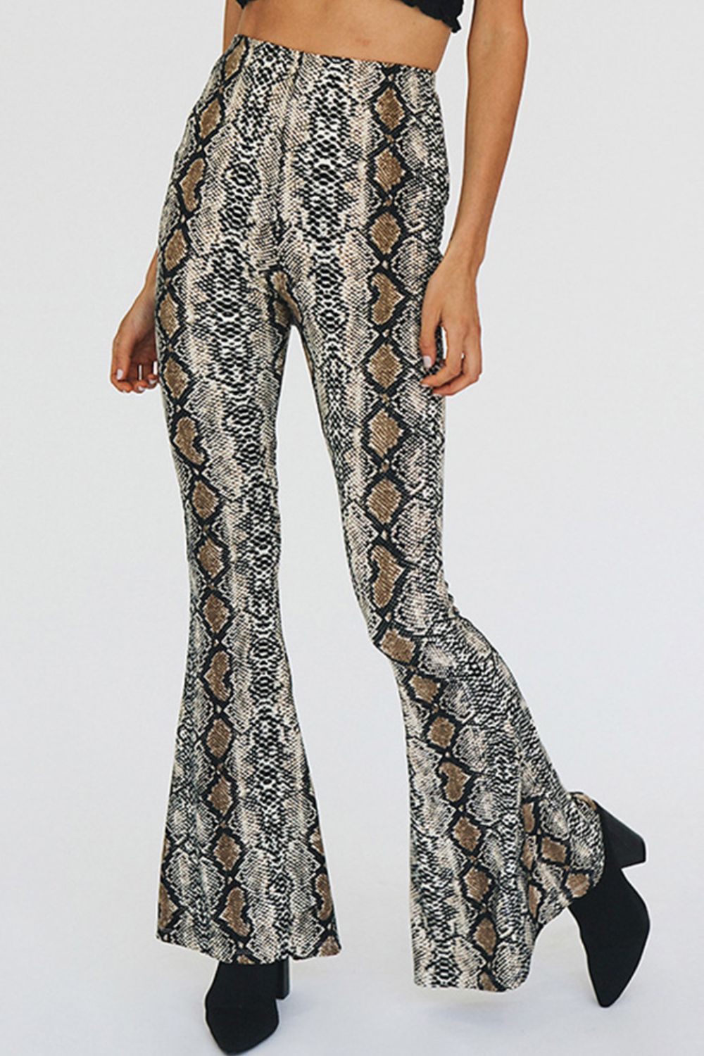 Serpentine bell-bottom pants in snakeskin print with a second skin fit.