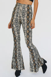 Serpentine bell-bottom pants in snakeskin print with a second skin fit.