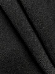 Black knit fabric detail of a drape-front blazer with sculpted silhouette.