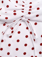White polka dot camisole with ruched detail and tie front.