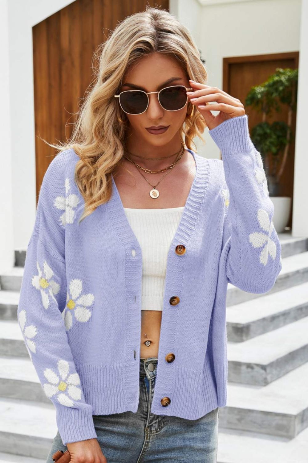 Lilac acrylic button-down cardigan with white daisy embroidery and brown buttons.