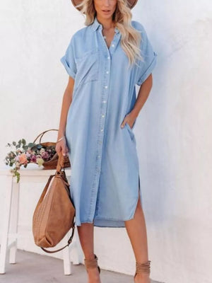 Light blue denim midi shirt dress with short sleeves, button front, pockets, and side slits.