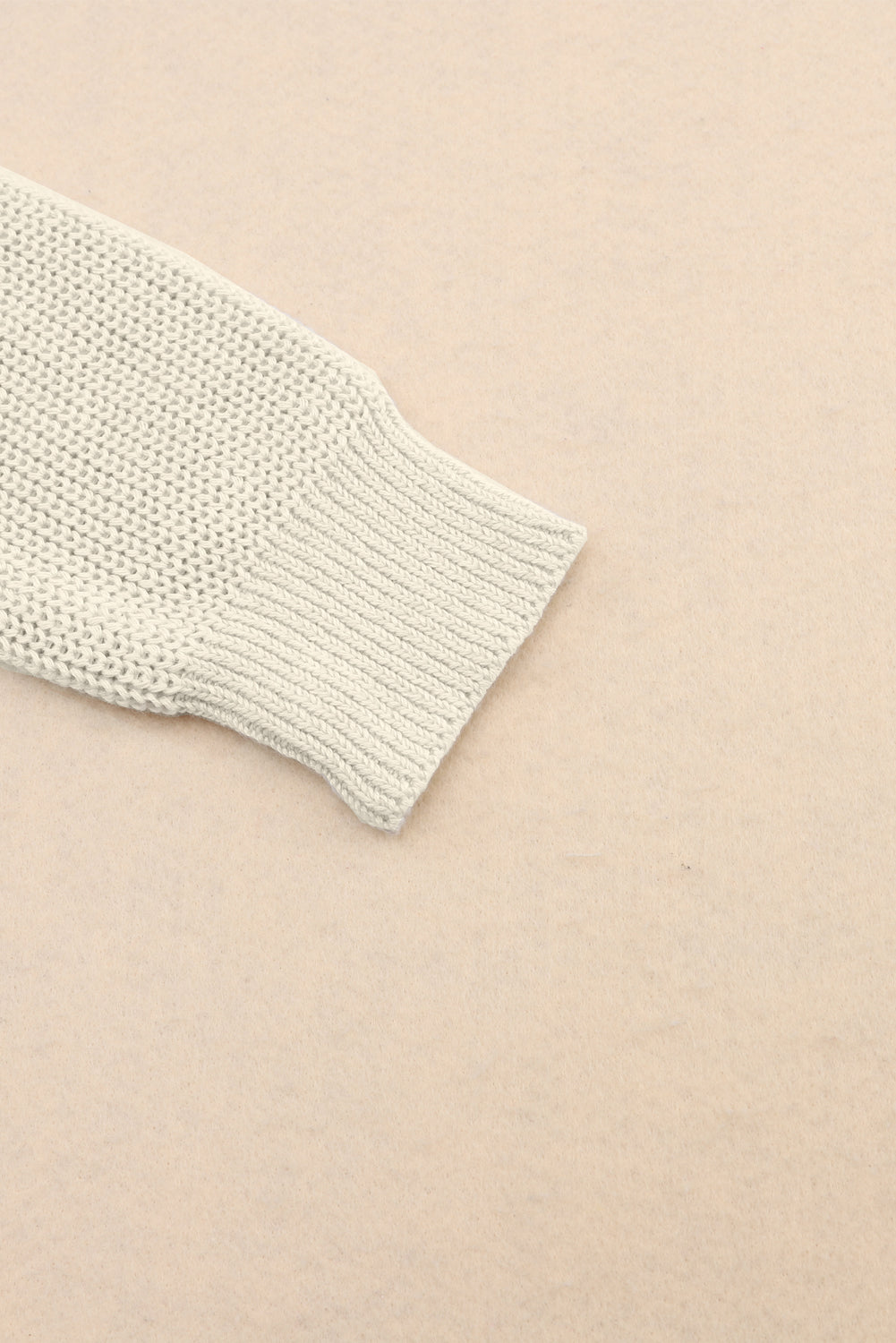 Relaxed knit v-neck pullover sweater in beige with ribbed cuff detail