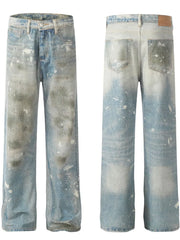 Distressed wash wide leg denim jeans in medium blue with paint splatters and faded details.