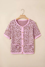 Short sleeve leopard print cardigan with button front and pockets in acrylic blend.
