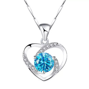 Silver heart pendant necklace with blue zircon and crystal accents