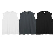 Sleeveless asymmetric panel tank tops in black, white, and dark gray.